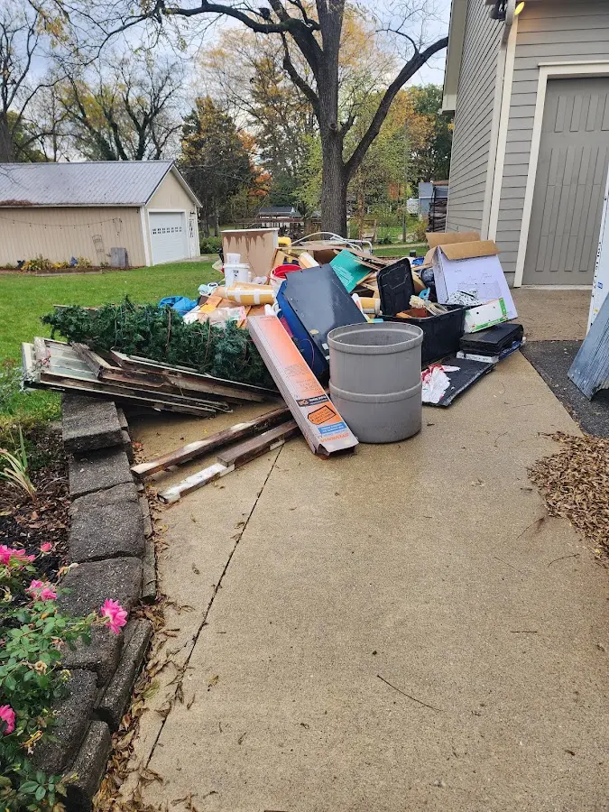 Dumpster being loaded with debris for 30 Yard Dumpster Rental in Libby